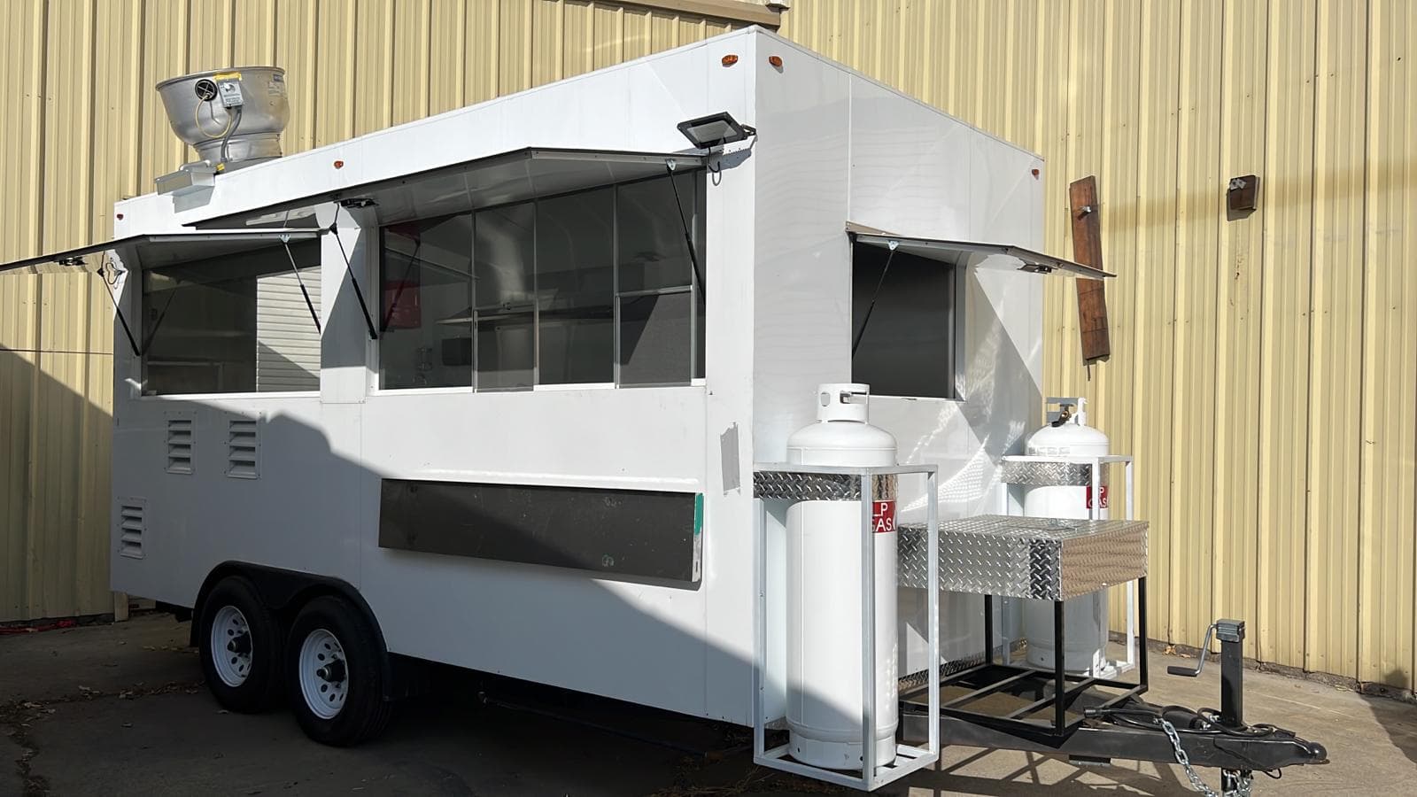 Delivered food trailer in a plain white finish with the windows open